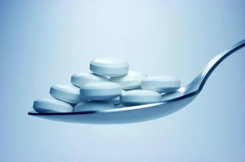 Spoon with pills Stock Photos