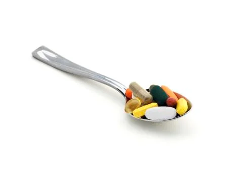 Spoon with pills Stock Photos