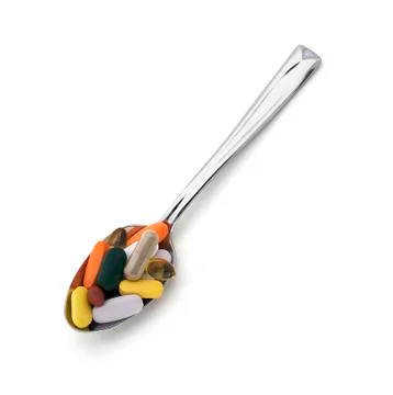 Spoon with pills Stock Photos