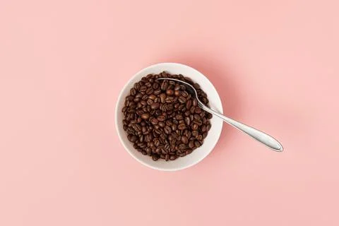 Spoon in a plate with coffee beans Stock Photos