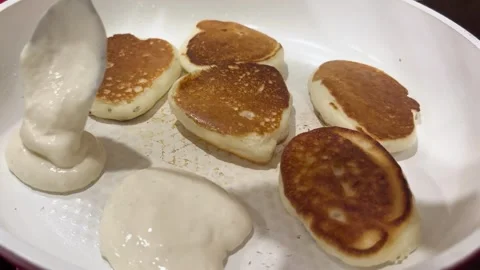 Spoon puts dough on a frying pan for frying pancakes Stock Footage 271573513