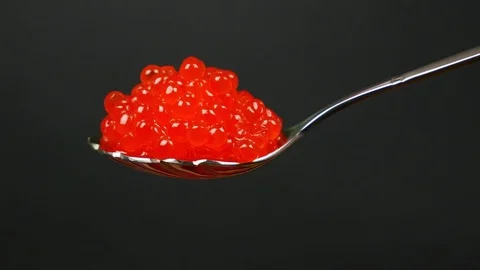 A spoon of red caviar on the black background. Stock Footage 84074516