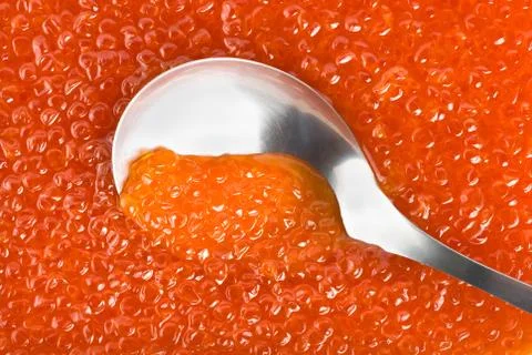 Spoon into red caviar Stock Photos