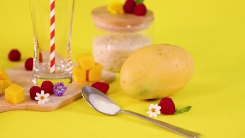Spoon Removes Mango and Fruit Garnish from Cutting Board Stock Footage 321666411