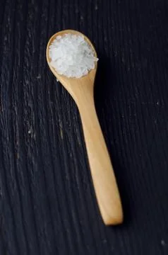 Spoon with salt Stock Photos