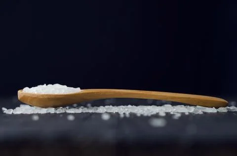 Spoon with salt Stock Photos