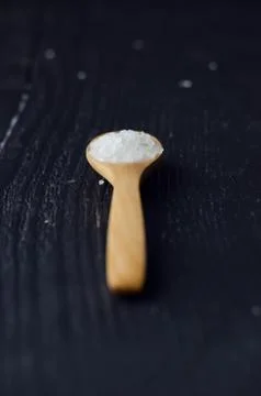 Spoon with salt Stock Photos