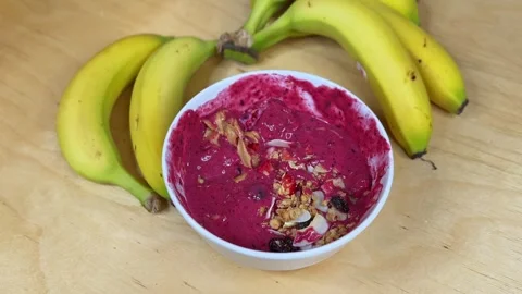 Spoon Scooping Bite from Acai Smoothie Bowl with Peanut Butter, Granola &amp; Stock Footage 320468753