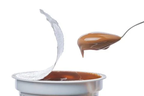 Spoon scooping dulce de leche out of a pot, traditional sweet from Argentin.. Stock Photos