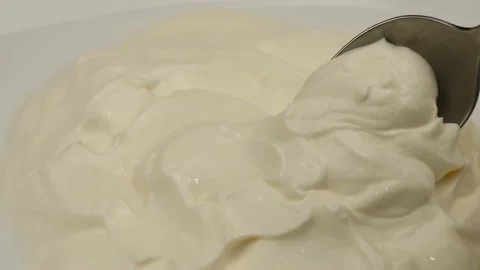 A spoon scoops up sour cream 스톡 동영상 188717325
