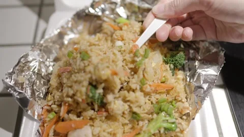 Spoon scoops takeout fried rice from kitchen counter Stock Footage 305791973