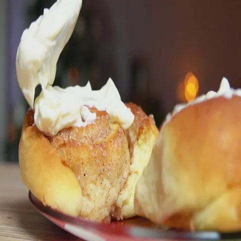 Spoon smears cream on a bun Video stock 69409456