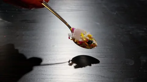 Spoon Spreading Plastic Debris on Table, Highlighting Microplastic Health Risks Vídeo Stock 297193106