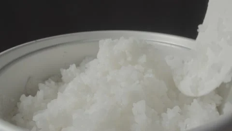 Spoon stir cooked white Thai jasmine rice in a rice cooker bowl. Stock Footage 235614865