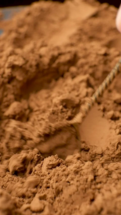 Spoon stirring dry cocoa powder vertical slow motion Stock Footage 334872853