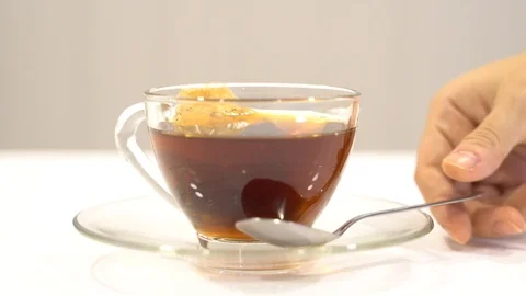 Spoon stirring tea bag in cup glass Stock Footage 109560523
