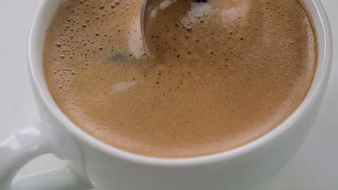 Spoon stirs coffee foam Stock Footage 74674630
