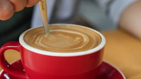 Spoon stirs sugar into coffee. Stock Footage 272579000