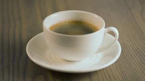 A spoon of sugar is added to a cup of coffee. Stock Footage 109230529