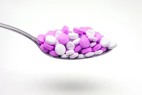 Spoon with tablets Stock Photos