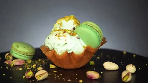 Spoon take a bite of green pistachio ice cream with macaroons, 4K nut crumbs Stock Footage 157105486