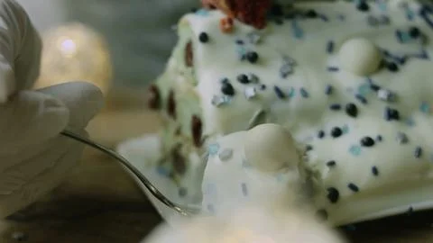Spoon taking a creamy bite from the decorated dessert Stock Photos