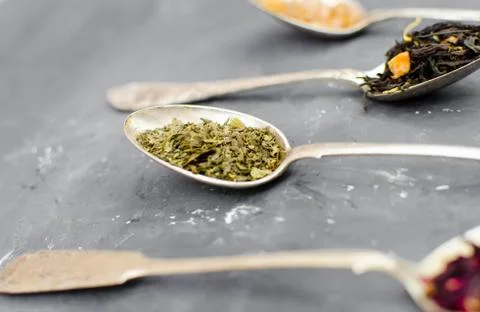 Spoon with tea on the table Stock Photos