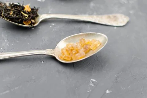 Spoon with tea on the table Stock Photos