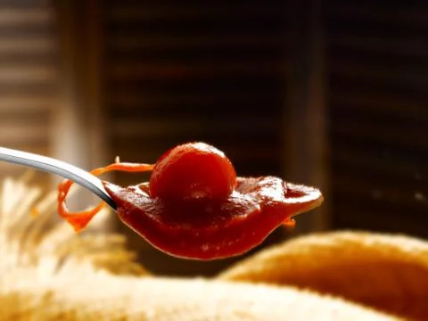 Spoon with tomato sauce Stock Photos