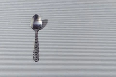 Spoon top close-up isolated on light background. Stock Photos