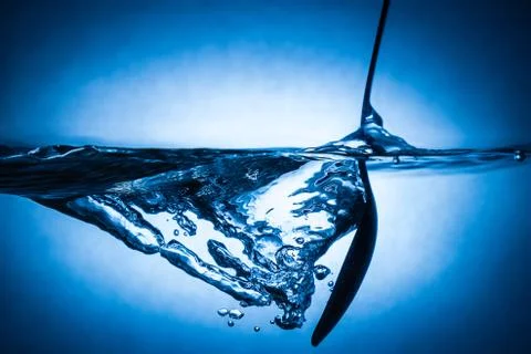 Spoon in water Stock Photos