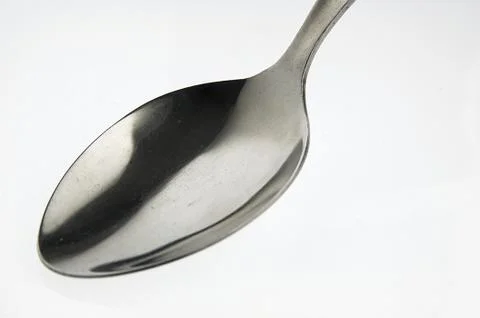 Spoon on the white table. Stock Photos