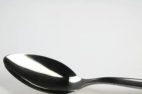 Spoon on the white table. Stock Photos