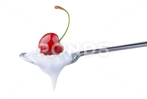 Spoon of yoghurt with cherry on top Stock Photos