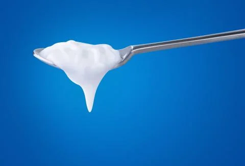 A spoon with yoghurt Stock Photos