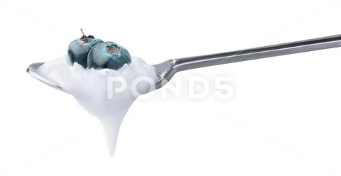 Spoon of yogurt with blueberries on top Stock Photos