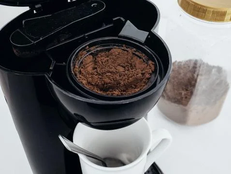 Spoonful of Coffee in Coffee Maker Machine Stock Photos