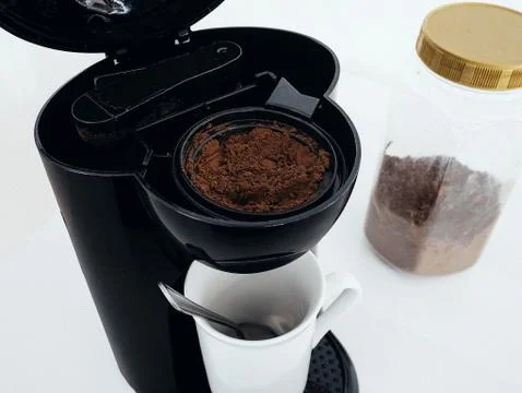Spoonful of Coffee in Coffee Maker Machine Stock Photos