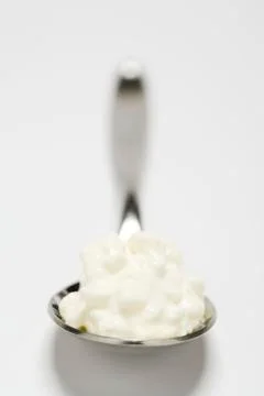 Spoonful of cottage cheese on white background Foto stock