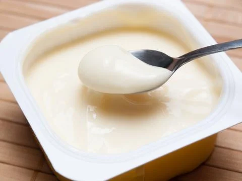 Spoonful of custard Stock Photos