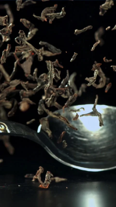 A spoonful of dry tea falls on the table. Filmed on a high-speed camera at 1000 Stock Footage 335368797