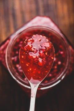 Spoonful of homemade raspberry jam Stock Photos