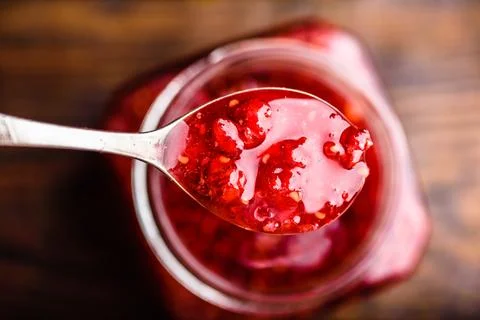 Spoonful of homemade raspberry jam Stock Photos