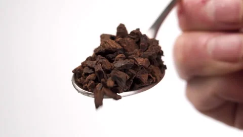Spoonful of instant chicory root in hand. Falling fried granules in slow moti Stock Footage 152147742