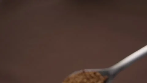 Spoonful of Instant Coffee Granules on brown background. Stock Footage 285489108