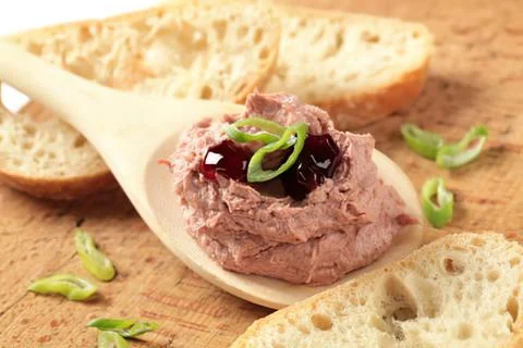 Spoonful of meat spread with jam on bread Stock Photos