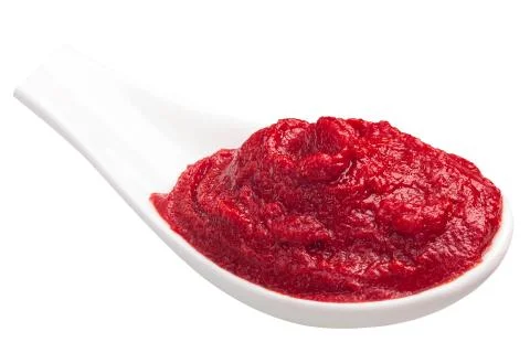 Spoonful of tomato paste or puree Stock Photos
