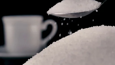 Spoonful of white sugar added in cup of coffee on black Stock Footage 81179728