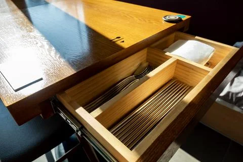 Spoons, Chopsticks and Pattern Imprinted Napkins in a side drawer Stock Photos