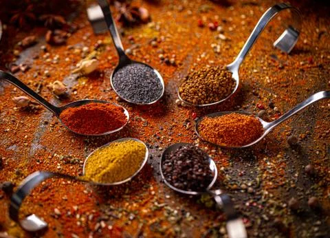 Spoons with different spices Foto stock